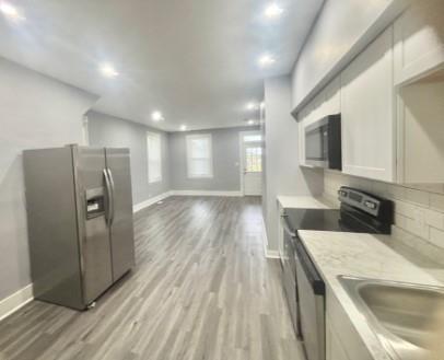 400 Prospect Street, Unit B Jeannette, PA 15644 - Photo 4 of 10 a kitchen with stainless steel appliances granite countertop a refrigerator a sink a stove and oven