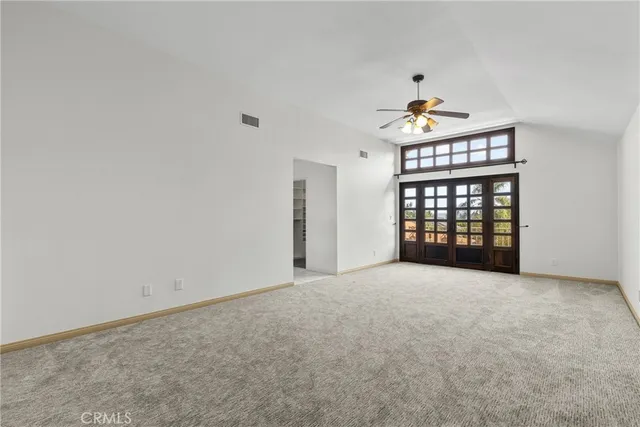 an empty room with windows and closet