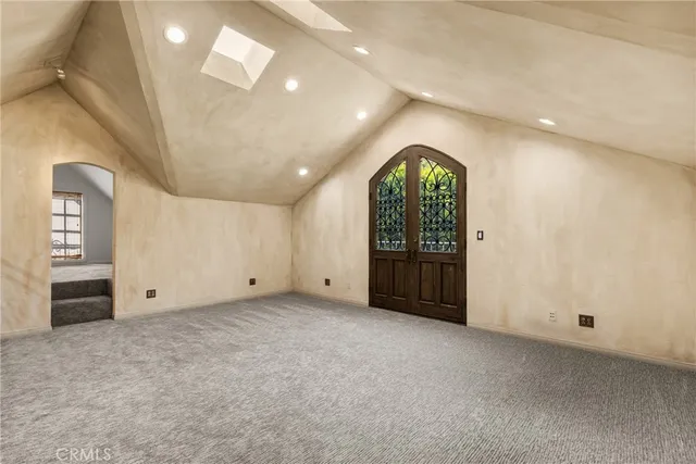 an empty room with a window and mirror