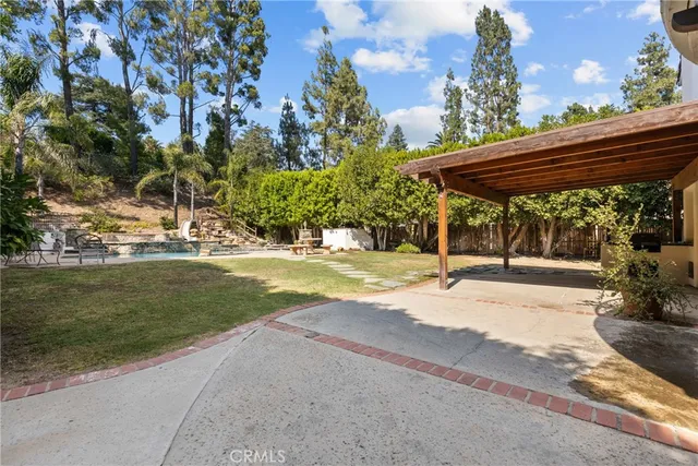 a view of a patio with a table and chairs under an umbrella
