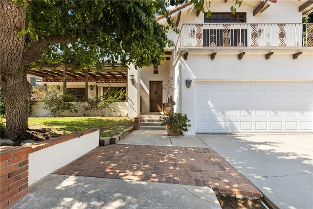 a view of a white house with a yard