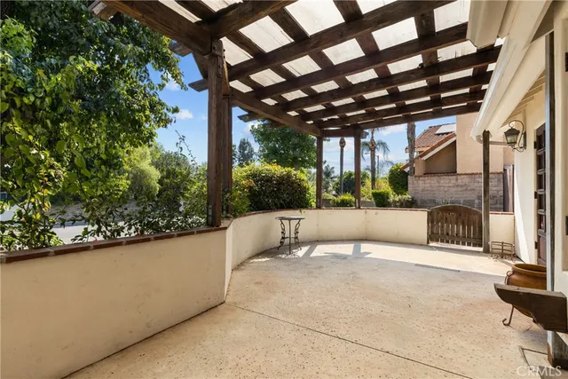 a view of a patio with a table and chairs