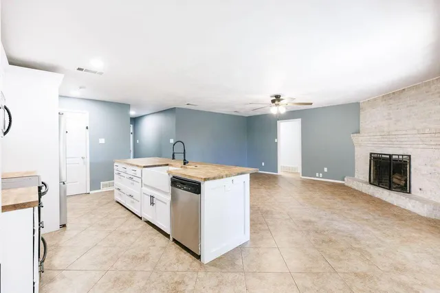 a kitchen with granite countertop a sink and stainless steel appliances