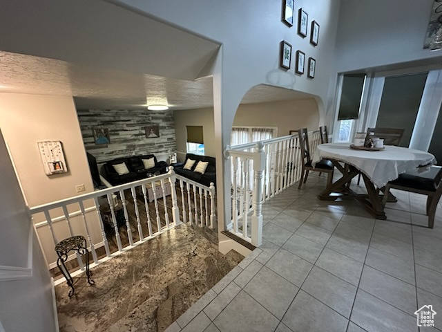 1874 South Main Street Orem, UT 84058 - Photo 5 of 15 Corridor featuring tile patterned flooring, an upstairs landing, and a high ceiling
