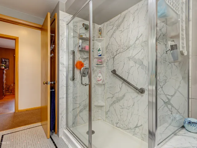 a bathroom with a shower and a glass door