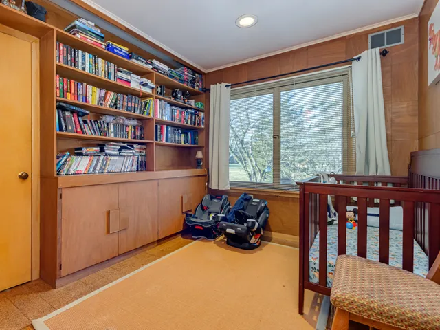 a room with furniture book shelf and a window