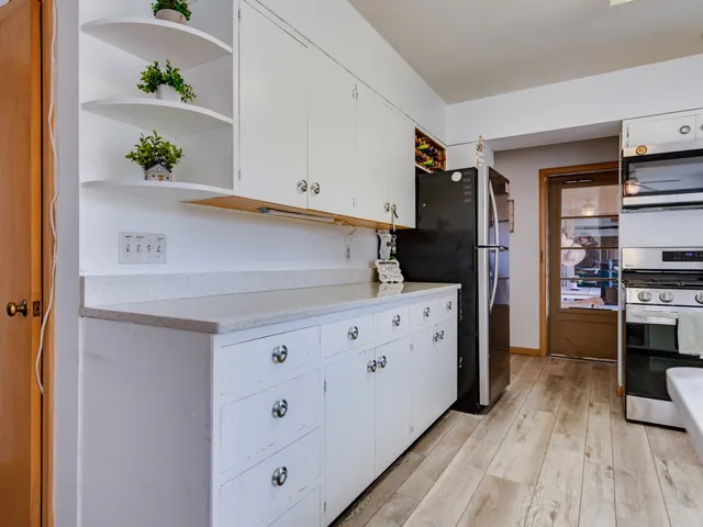 a kitchen with cabinets and a wooden floor