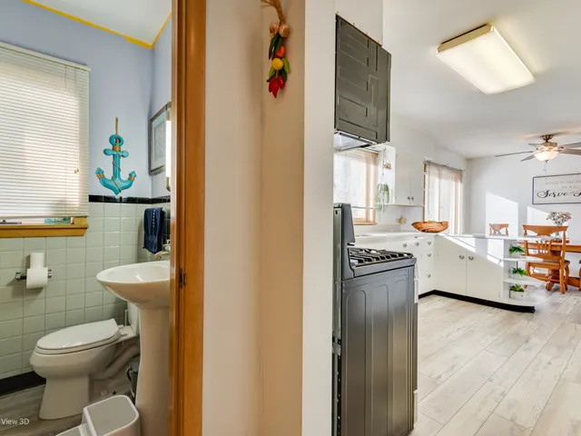 a view of bathroom with a toilet sink and mirror