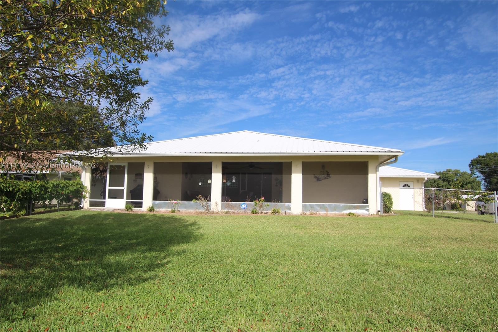 2009 Hunter Road Okeechobee, FL 34974 - Photo 3 of 43 a front view of a house with a garden and trees