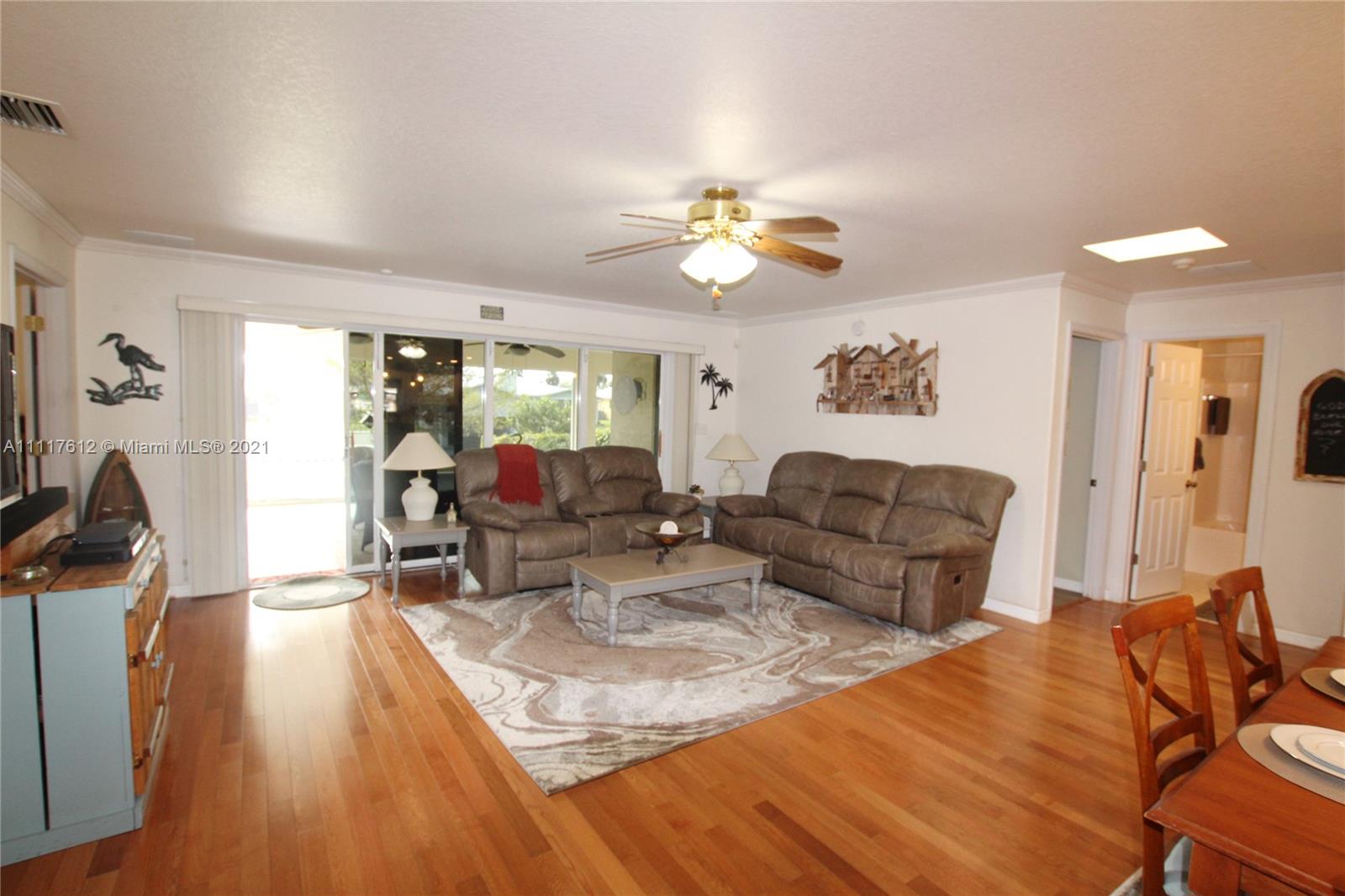 2009 Hunter Road Okeechobee, FL 34974 - Photo 22 of 43 a living room with furniture fireplace and a large window