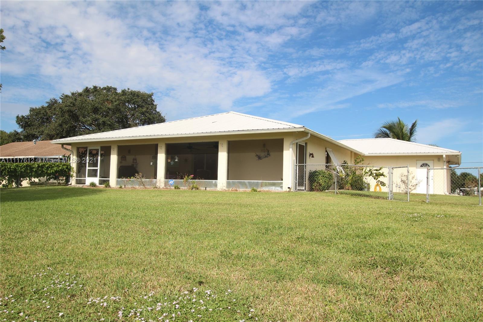 2009 Hunter Road Okeechobee, FL 34974 - Photo 4 of 43 a front view of a house with a garden