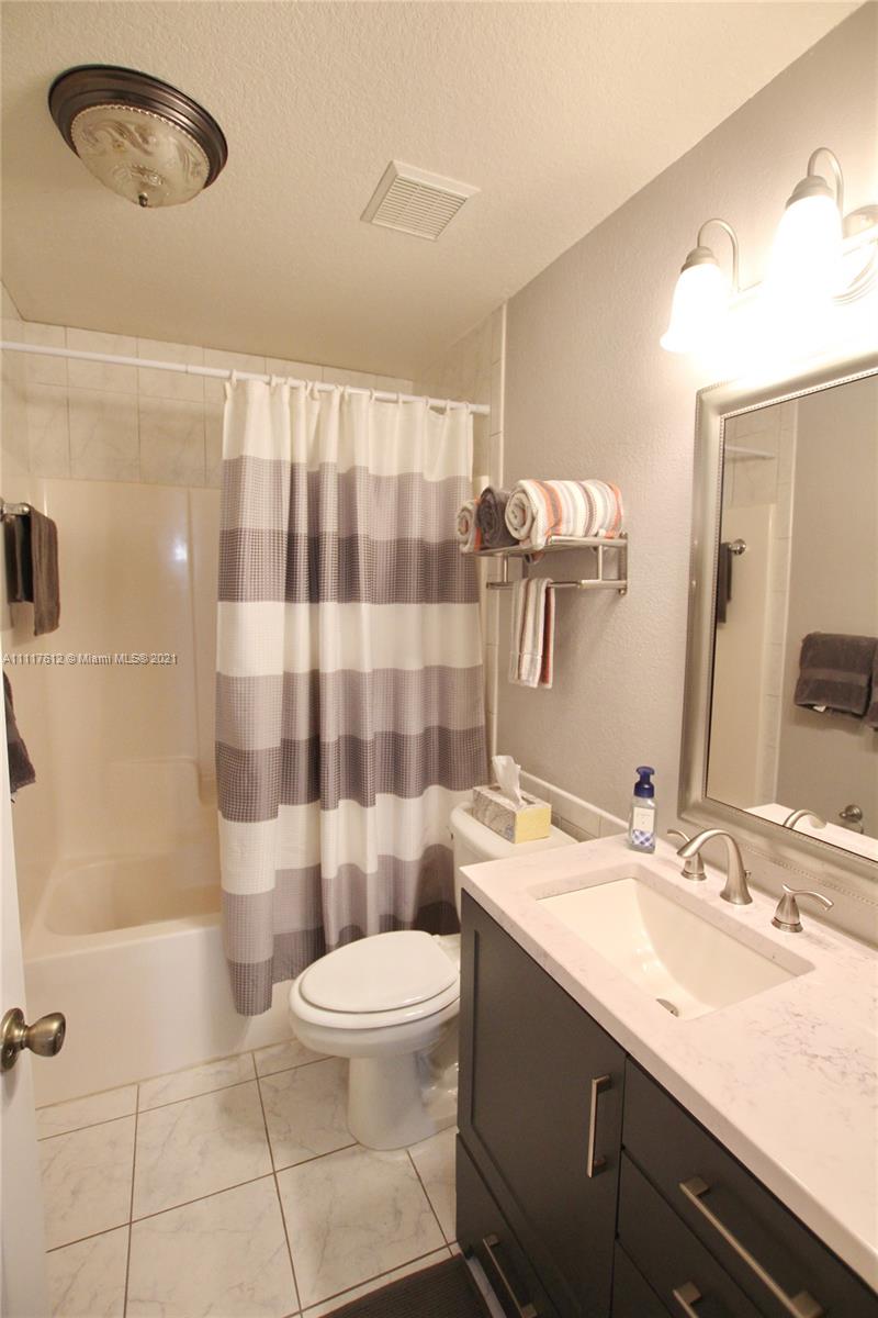 2009 Hunter Road Okeechobee, FL 34974 - Photo 36 of 43 a bathroom with a sink a toilet a mirror and shower