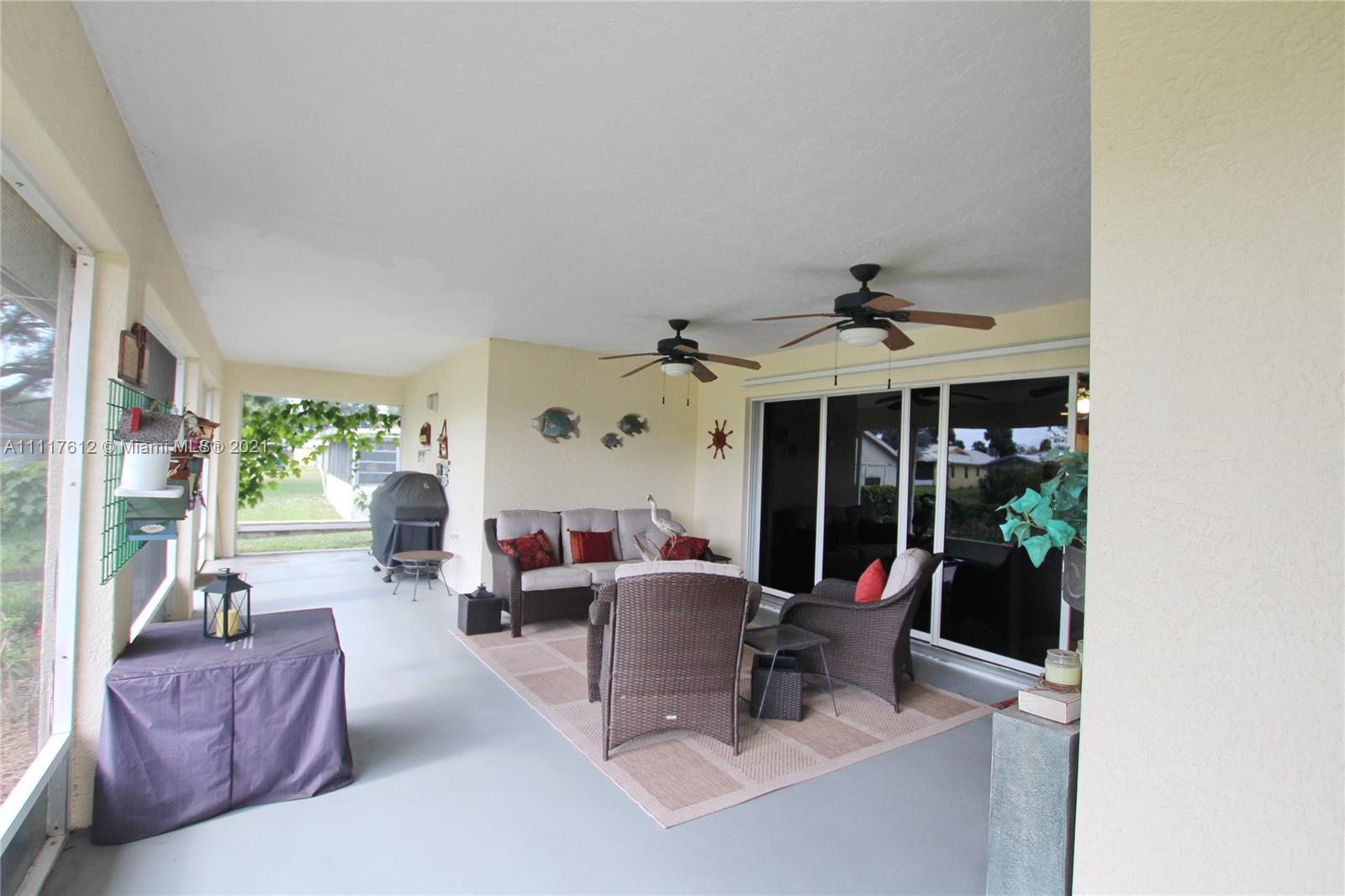 2009 Hunter Road Okeechobee, FL 34974 - Photo 40 of 43 a living room with furniture a window and potted plants