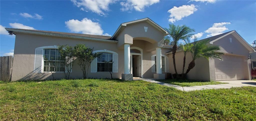 263 Delake Road Northwest Palm Bay, FL 32907 - Photo 1 of 1 a front view of house with yard and green space