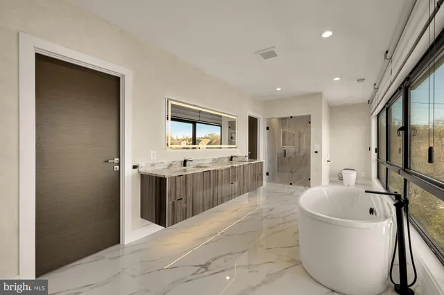 a large bathroom with a tub and mirror