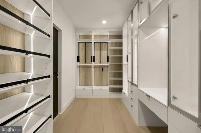 a view of walk in closet with empty racks