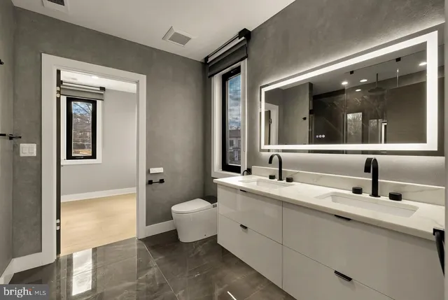a bathroom with a granite countertop sink mirror and bathtub