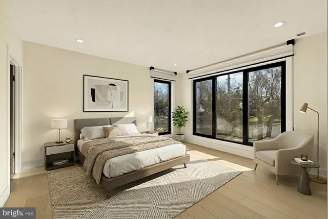 a bedroom with a large bed and a large window