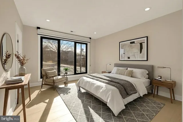 a spacious bedroom with a large bed and a large window