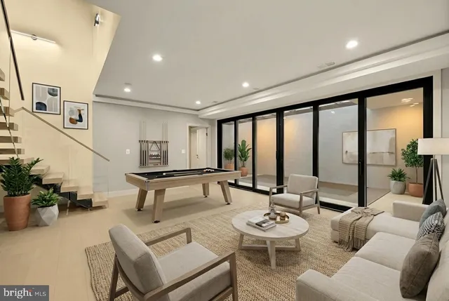 a living room with furniture and floor to ceiling windows