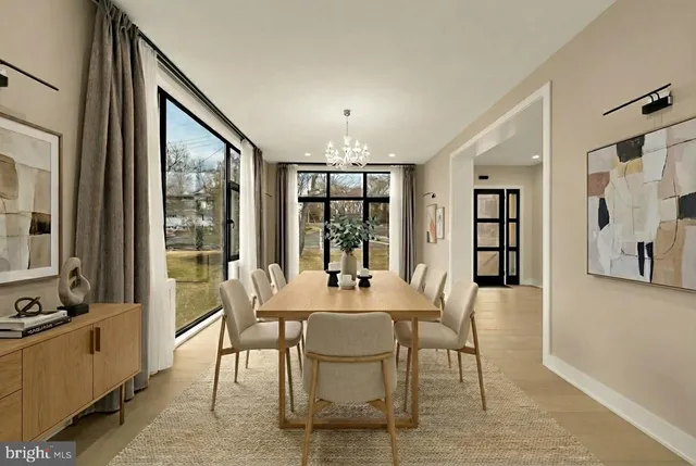 a dining room with furniture a chandelier and wooden floor