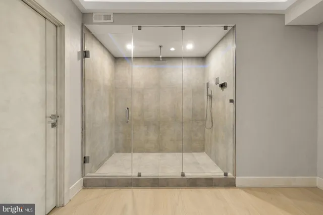 a bathroom with a shower and tub