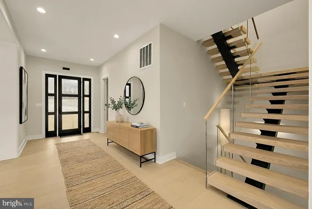 a view of entryway and hall with wooden floor