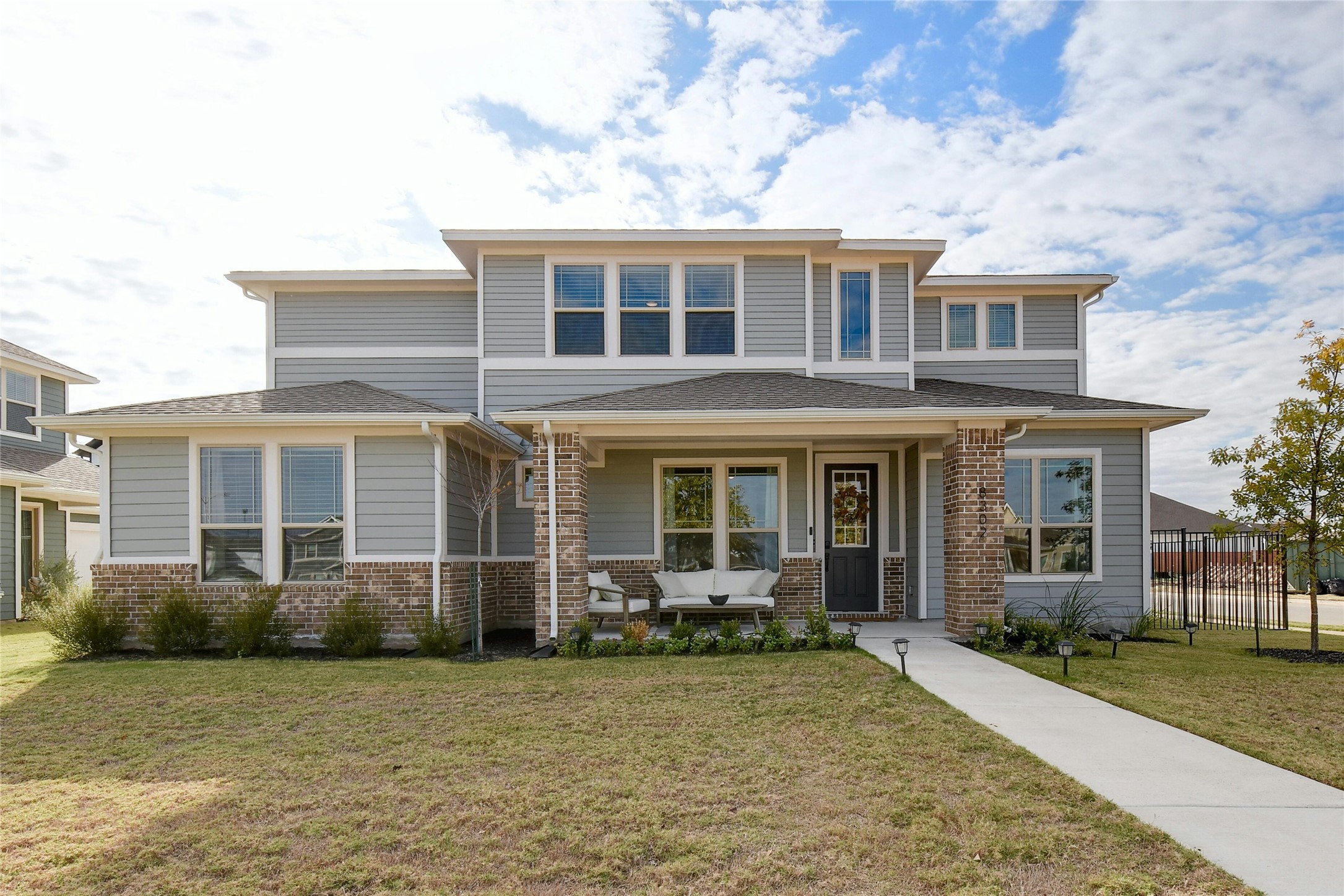 Prairie-style house with a porch and brick siding