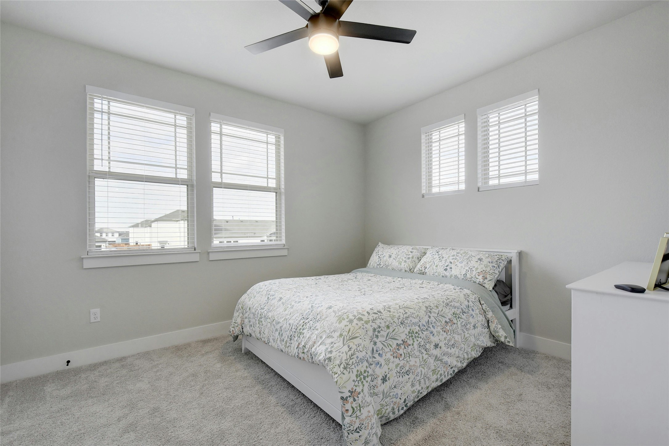 8302 Corrigan Pass Austin, TX 78744 - Photo 23 of 30 Carpeted bedroom featuring baseboards and a ceiling fan