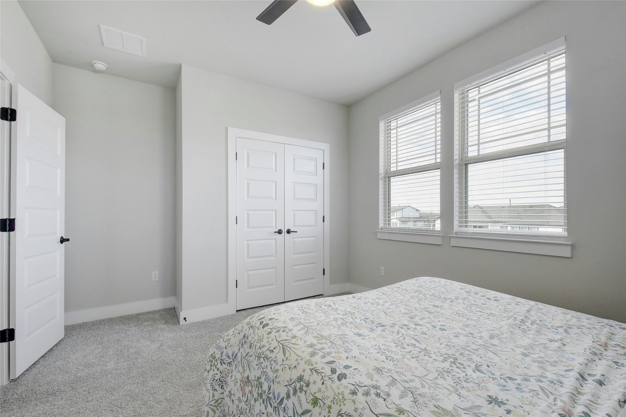 8302 Corrigan Pass Austin, TX 78744 - Photo 24 of 30 Bedroom featuring light colored carpet, a closet, and ceiling fan