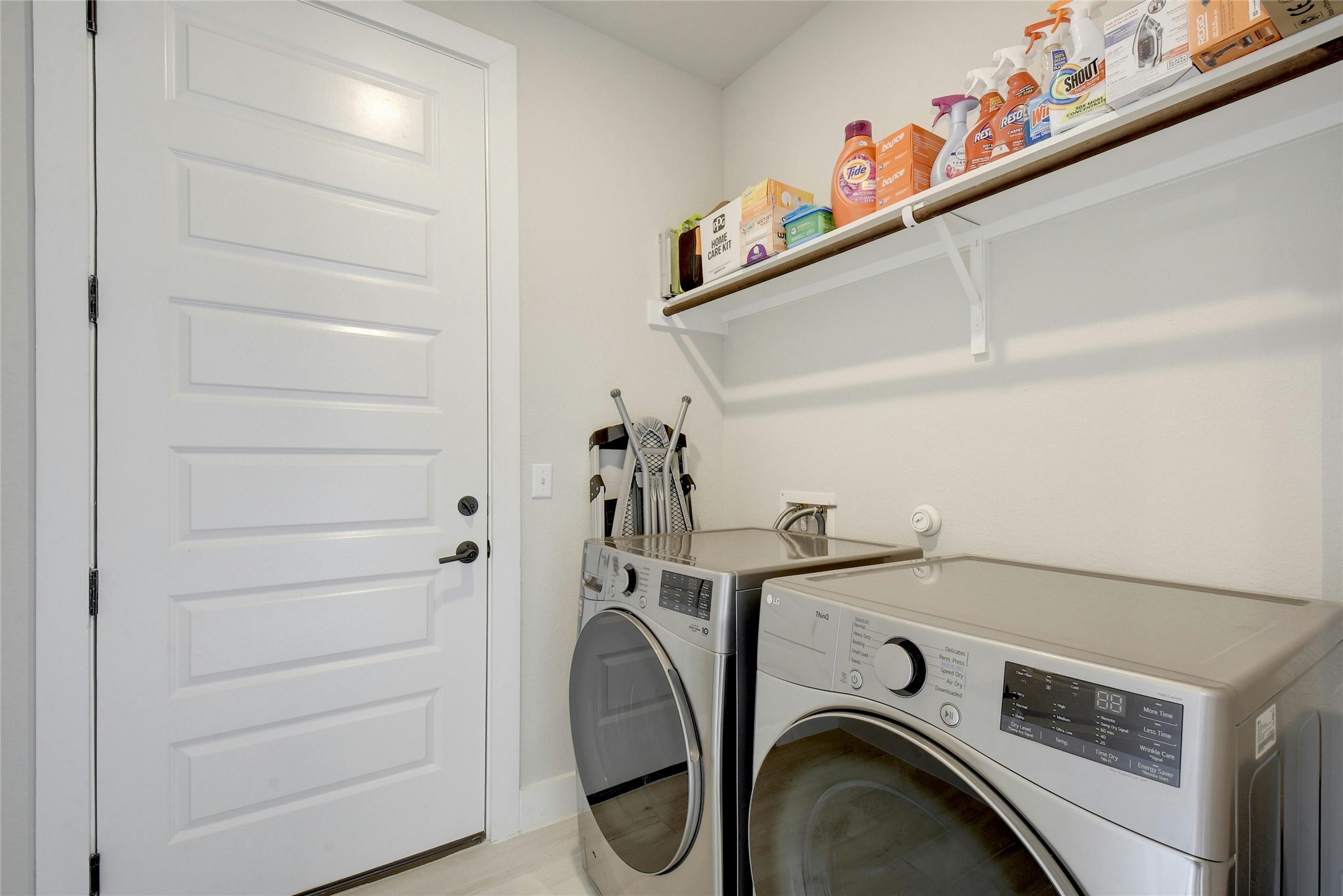 8302 Corrigan Pass Austin, TX 78744 - Photo 26 of 30 Laundry area with washer and dryer and baseboards