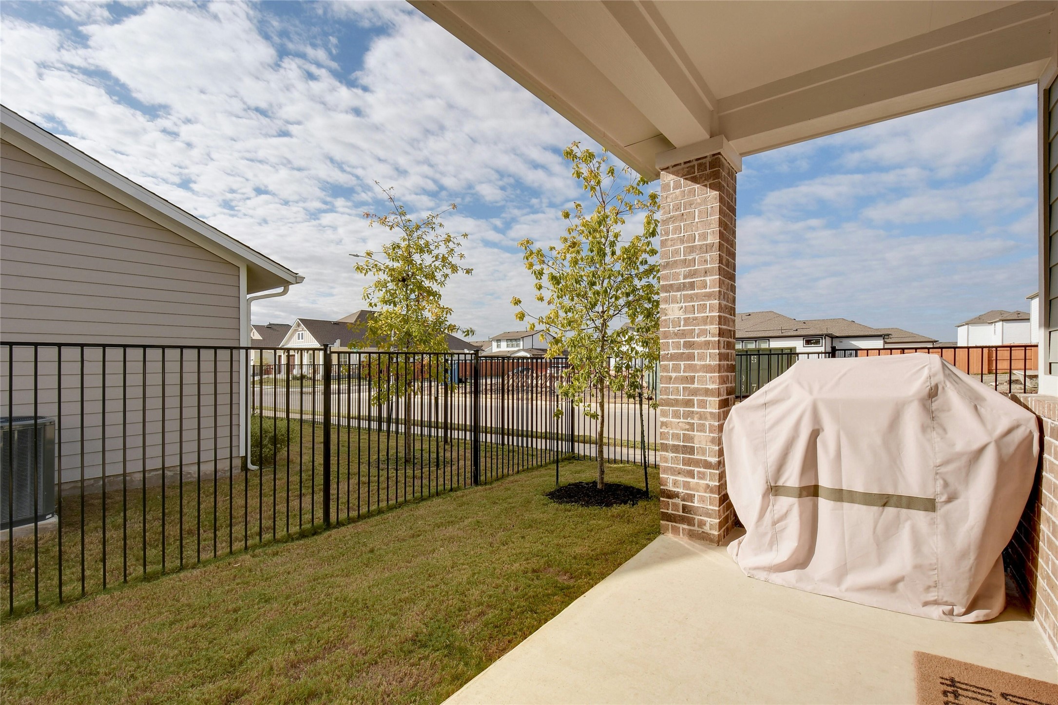 8302 Corrigan Pass Austin, TX 78744 - Photo 28 of 30 Fenced backyard with a patio and a residential view