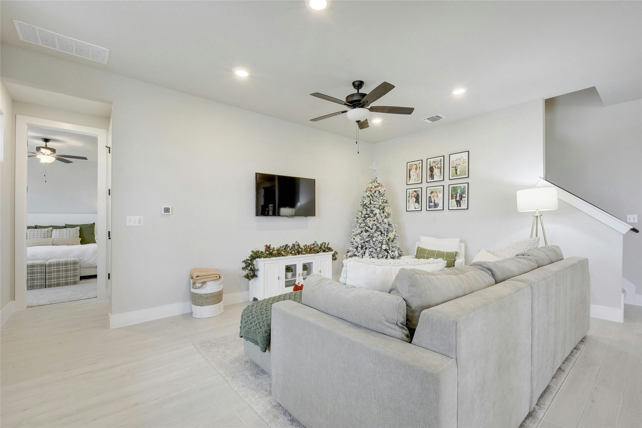 8302 Corrigan Pass Austin, TX 78744 - Photo 5 of 30 Living room with a ceiling fan, recessed lighting, and light wood-style flooring