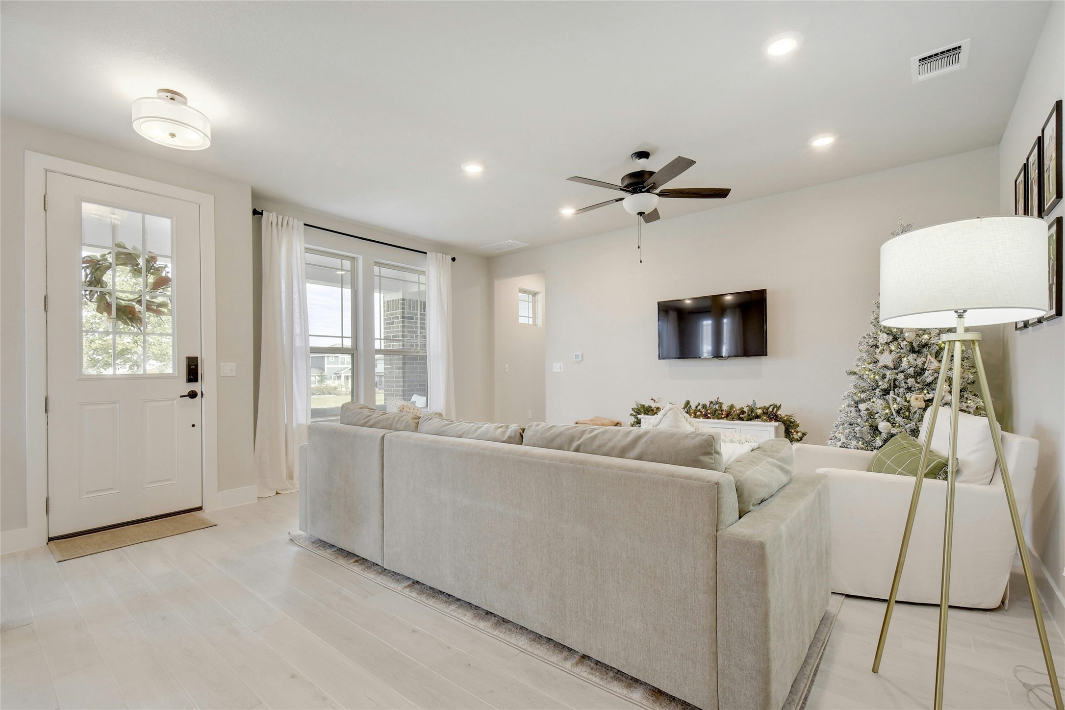 8302 Corrigan Pass Austin, TX 78744 - Photo 6 of 30 Living area with light wood-type flooring, ceiling fan, and recessed lighting