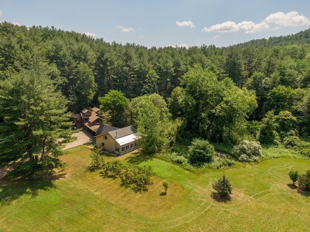 253 Long Plain Road Leverett, MA 01054 - Photo 1 of 42 a view of a lake in middle of forest