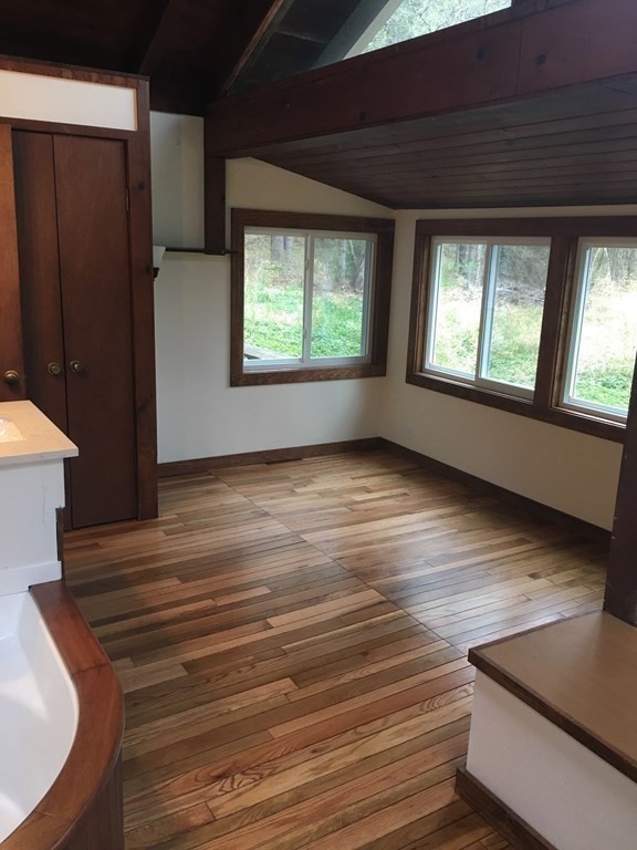 253 Long Plain Road Leverett, MA 01054 - Photo 12 of 42 an empty room with wooden floor and windows