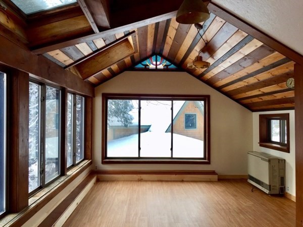 253 Long Plain Road Leverett, MA 01054 - Photo 16 of 42 a view of an empty room with wooden floor and a window