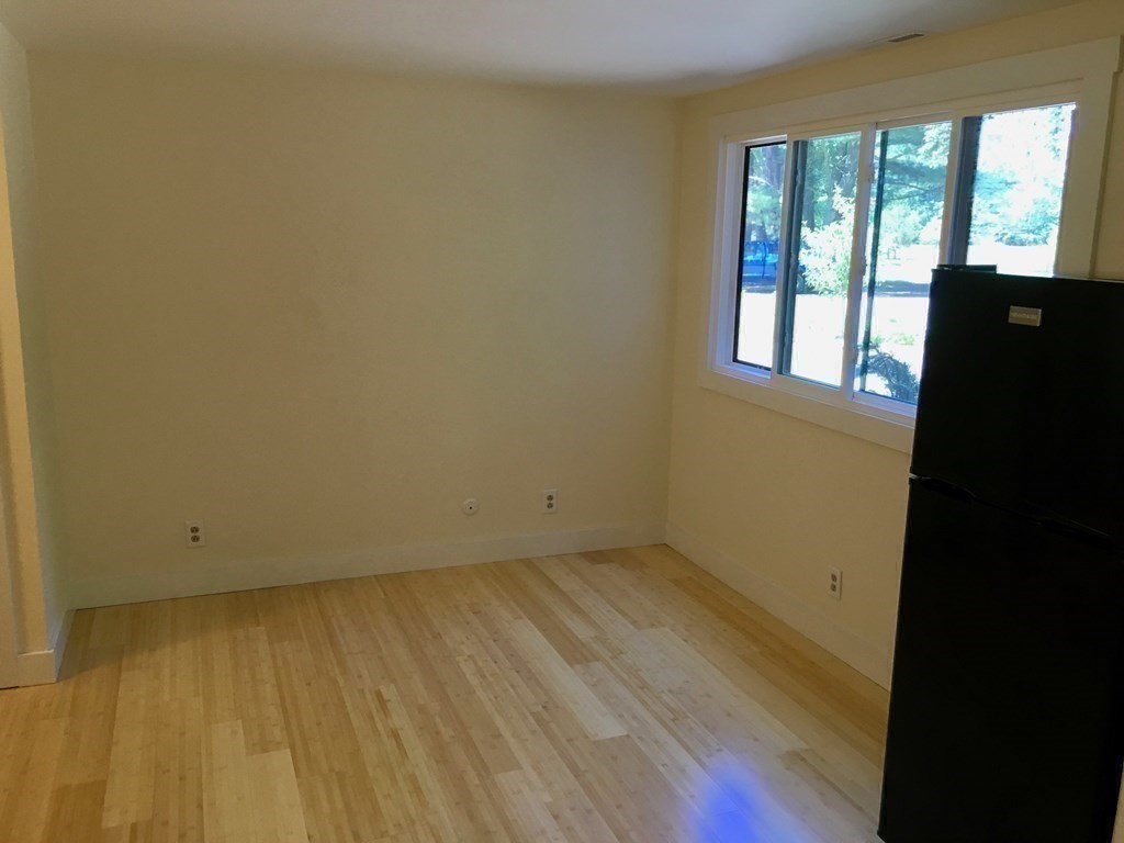 253 Long Plain Road Leverett, MA 01054 - Photo 24 of 42 a view of an empty room with wooden floor and a window