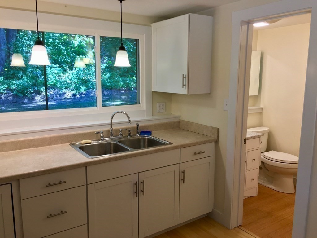 253 Long Plain Road Leverett, MA 01054 - Photo 25 of 42 a kitchen with a sink and cabinets