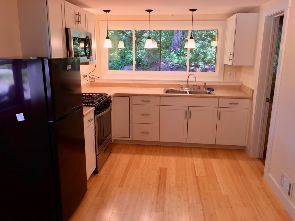253 Long Plain Road Leverett, MA 01054 - Photo 28 of 42 a kitchen with a sink and wooden floor