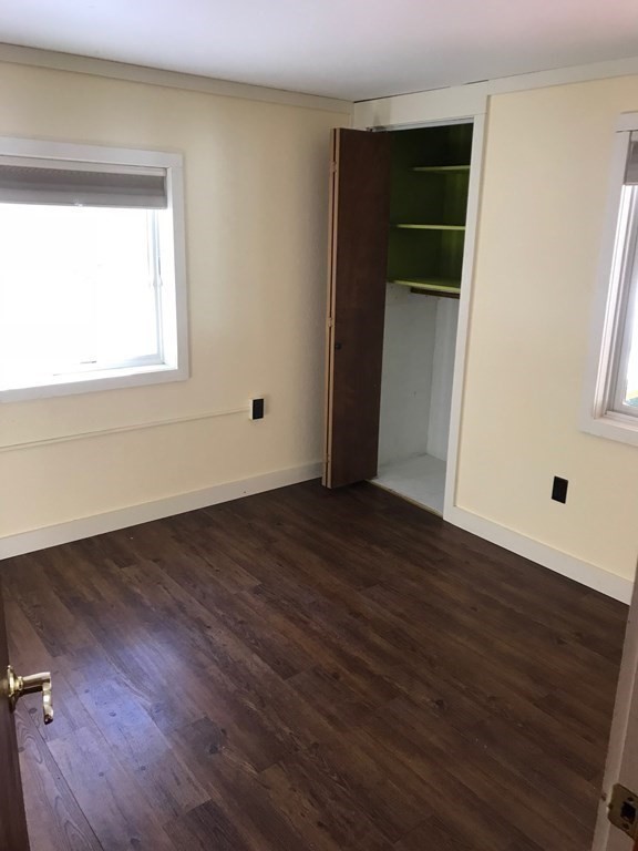 253 Long Plain Road Leverett, MA 01054 - Photo 32 of 42 an empty room with wooden floor and windows