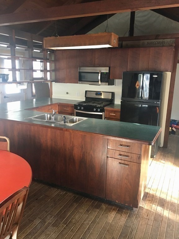 253 Long Plain Road Leverett, MA 01054 - Photo 6 of 42 a kitchen with stainless steel appliances granite countertop a stove a sink and a microwave