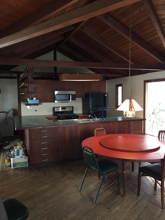 253 Long Plain Road Leverett, MA 01054 - Photo 7 of 42 a kitchen with a sink a table and chairs