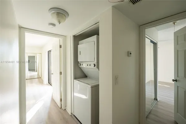 a view of a hallway with a livingroom and a bathroom