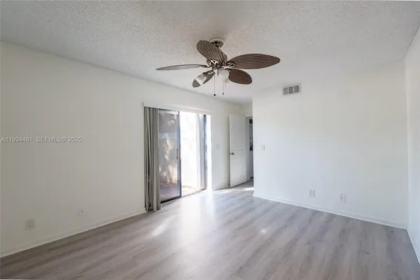 a view of an empty room and wooden floor