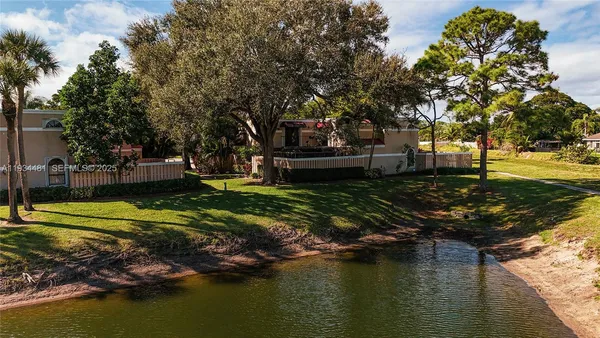 a swimming pool with wooden fence and trees
