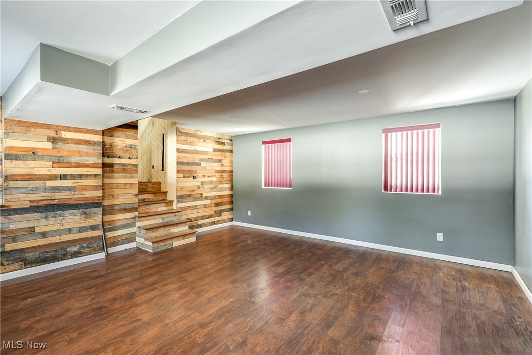 5865 Beach Road Wadsworth, OH 44281 - Photo 17 of 33 Empty room featuring wood walls and hardwood / wood-style floors