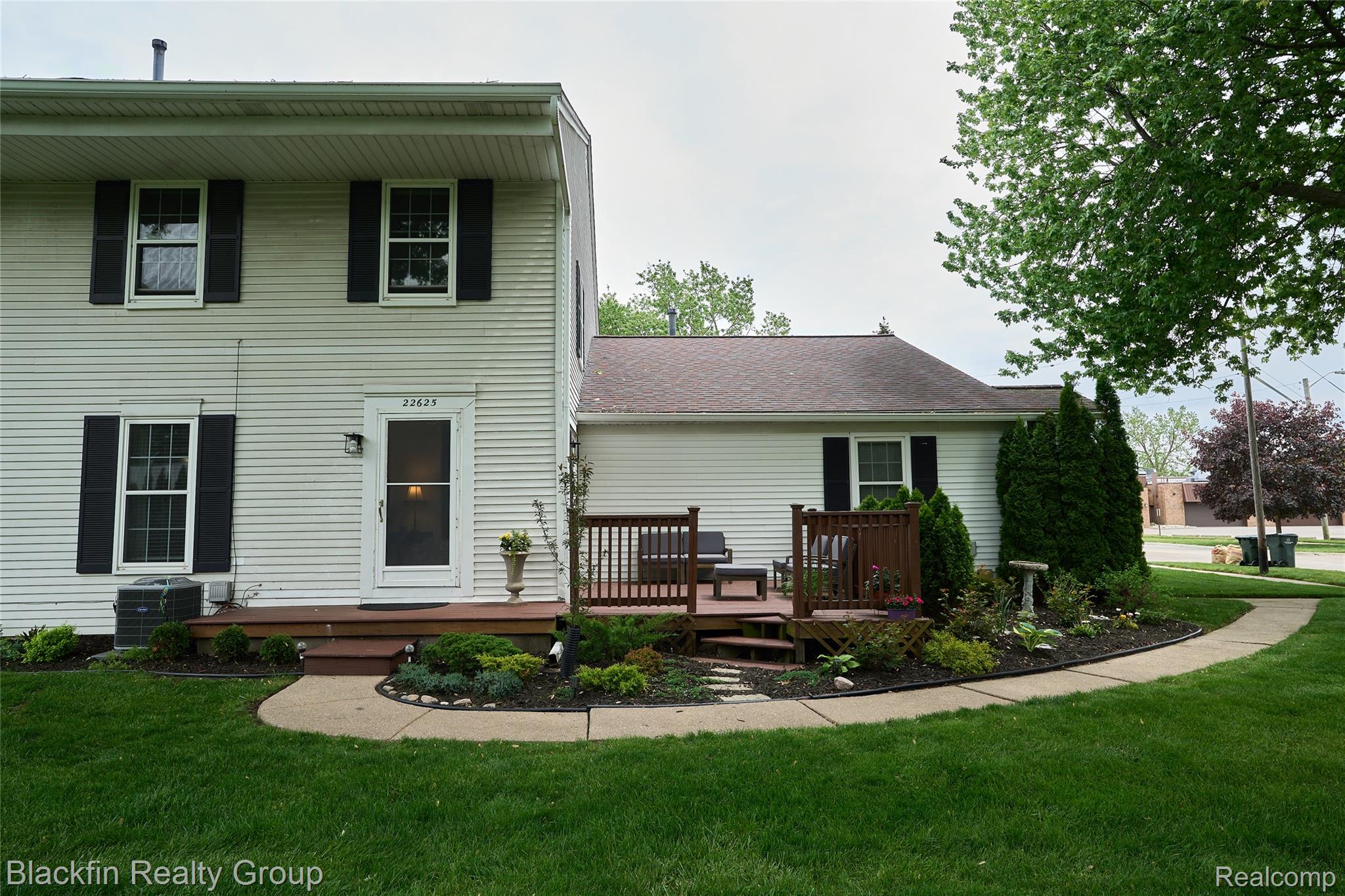 22625 Martin Road St. Clair Shores, MI 48081 - Photo 1 of 23 Rear view of house with a wooden deck, a yard, and a shingled roof