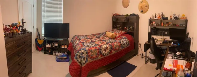 a bed sitting in a bedroom next to a window