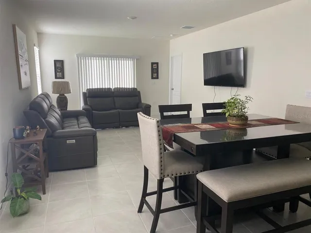 a work room with furniture and a flat screen tv